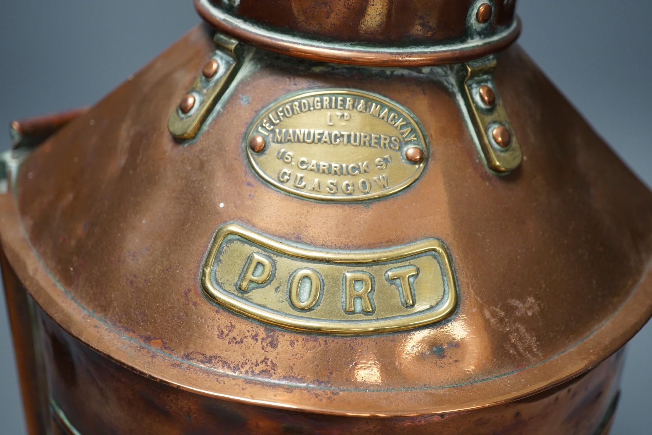 A copper ship’s port lamp, manufactured by Telford.Grier & Mackay, Glasgow, 1918, 42 cms high